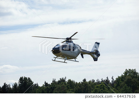 passenger helicopter flies at an air show 64437616