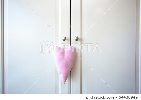 White doors of cupboard and pink decoration heart. retro wooden design background texture 64438949