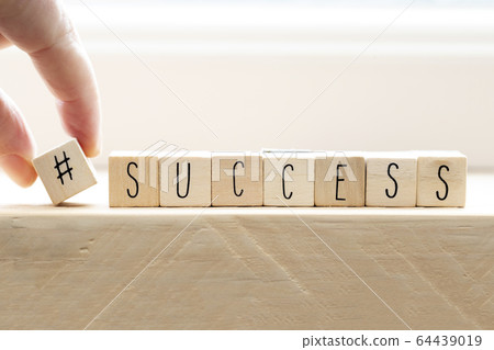 Hashtag with succes written wooden cubes, social media concept 64439019