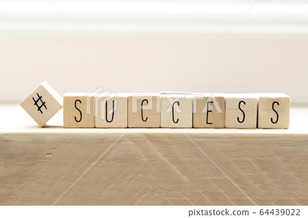 Hashtag with succes written wooden cubes, social media concept 64439022