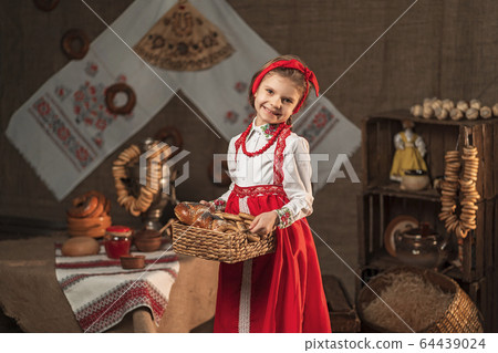 Pretty girl holding basket of bagels and other baking in traditional house Pretty girl holding basket of bagels and other baking in traditional house 64439024