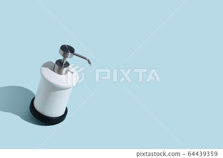 Dispenser for liquid soap on a blue background. Place for text Dispenser for liquid soap on a blue background. Place for text 64439359