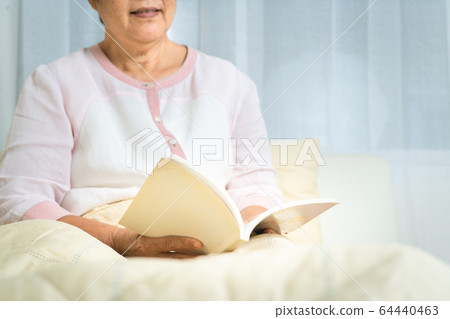 Covid-19 quarantine activity for senior woman read a book stay home to avoid risk Covid-19 quarantine activity for senior woman read a book stay home to avoid risk 64440463