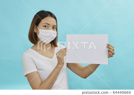 Women wearing masks holds a white sheet Women wearing masks holds a white sheet 64440669