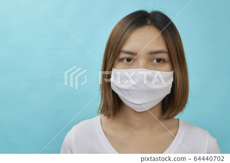 Brunette woman wearing face mask Brunette woman wearing face mask 64440702