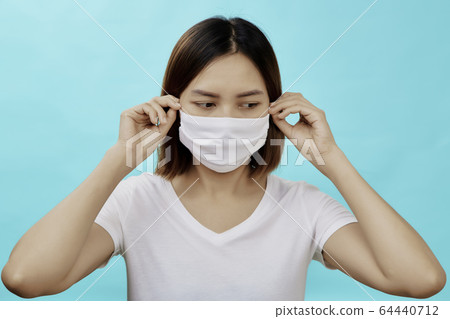Brunette woman wearing face mask 64440712
