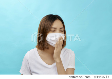 Brunette woman wearing face mask 64440714