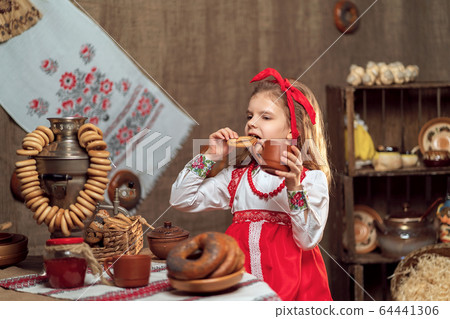 Adorable girl drinking tea from samovar 64441306