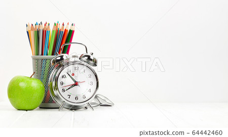 Office workplace with supplies and alarm clock Office workplace with supplies and alarm clock 64442460