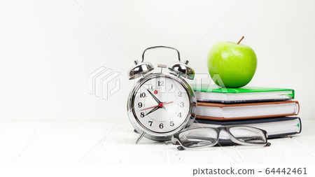 Office workplace with supplies and alarm clock Office workplace with supplies and alarm clock 64442461