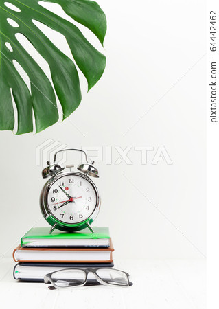 Office workplace with supplies and alarm clock Office workplace with supplies and alarm clock 64442462