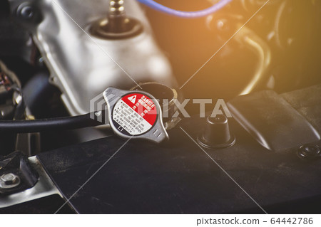Radiator cap is opened place on radiator. Radiator cap is opened place on radiator. 64442786
