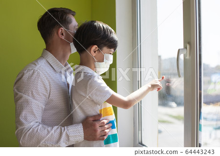 Father with son at home during the coronavirus quarantine. 64443243
