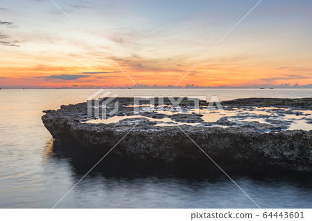 Lovely orange sunset and idyllic water surface in the sea  64443601