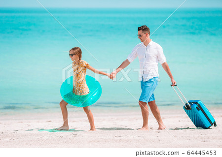 Little girl and happy dad having fun during beach vacation 64445453
