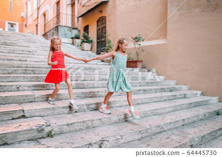 Adorable fashion little girls outdoors in European city Adorable fashion little girls outdoors in European city 64445730