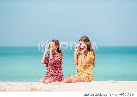 Cute little girls at beach during summer vacation Cute little girls at beach during summer vacation 64445739