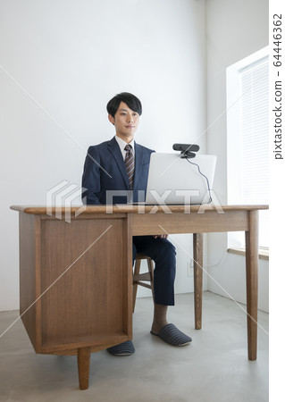 一個年輕人前往一台帶有網絡攝像頭在線採訪視頻聊天圖像的筆記本電腦 一個年輕人前往一台帶有網絡攝像頭在線採訪視頻聊天圖像的筆記本電腦 64446362