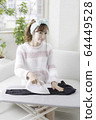 Woman ironing 64449528
