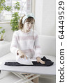 Woman ironing 64449529