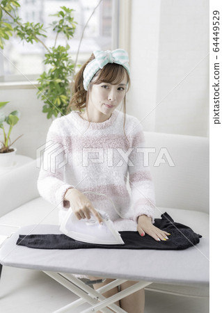 Woman ironing 64449529