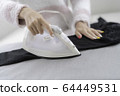 Woman ironing 64449531