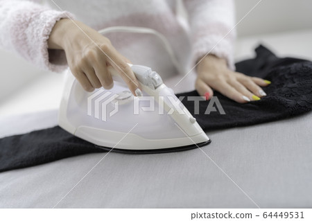 Woman ironing Woman ironing 64449531