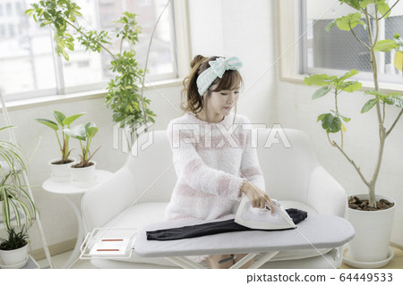 Woman ironing 64449533