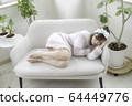 A woman resting in bed 64449776