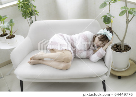 A woman resting in bed 64449776