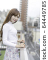 Woman on the roof of the building 64449785