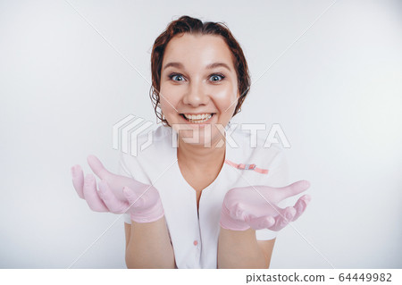 A crazy doctor with wild eyes and a smile holds out his hands. A woman in rubber gloves raises her palms. A girl wears protective clothing during an epidemic. Ads for antiseptics and medical equipment A crazy doctor with wild eyes and a smile holds out his hands. A woman in rubber gloves raises her palms. A girl wears protective clothing during an epidemic. Ads for antiseptics and medical equipment 64449982