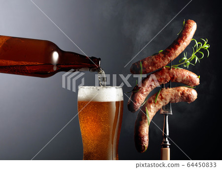 Beer and grilled Bavarian sausages with rosemary. 64450833