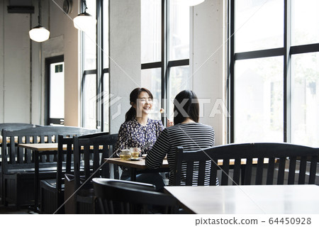 Woman eating pancake 64450928