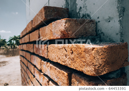 Construction of a brick wall Construction of a brick wall 64453391