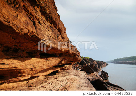 Large Sand stone canyon cliff shoreline of Mekong 64453522