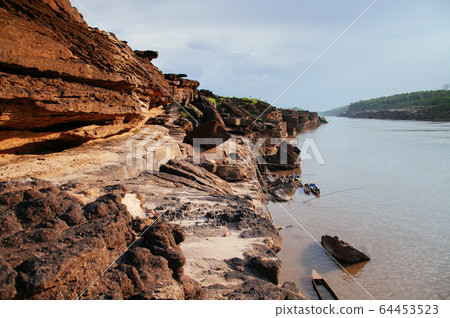 Large Sand stone canyon cliff shoreline of Mekong Large Sand stone canyon cliff shoreline of Mekong 64453523