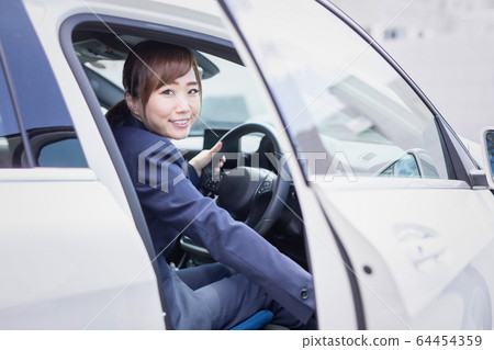 Business woman riding a car Business woman riding a car 64454359
