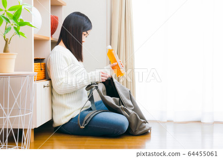 Woman's tea copy space to put plastic bottled beverages in her backpack 64455061