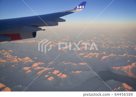 SAN FRANCISCO, CALIFORNIA, UNITED STATES - NOV 24th, 2018: Greenland view from airplane, frozen mountains or glaciers with wing view SAN FRANCISCO, CALIFORNIA, UNITED STATES - NOV 24th, 2018: Greenland view from airplane, frozen mountains or glaciers with wing view 64456389