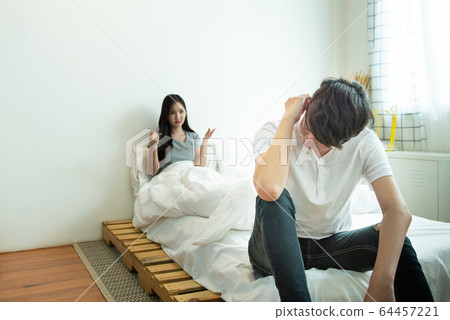 Asian man depresses and woman with unhappy relationship sit on bed Asian man depresses and woman with unhappy relationship sit on bed 64457221