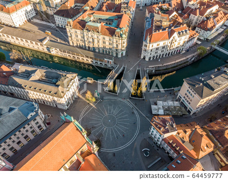 Aerial drone view of Preseren Squere and Triple Bridge over Ljubljanica river,Tromostovje, Ljubljana, Slovenia. Empty streets during corona virus pandemic social distancing measures Aerial drone view of Preseren Squere and Triple Bridge over Ljubljanica river,Tromostovje, Ljubljana, Slovenia. Empty streets during corona virus pandemic social distancing measures 64459777