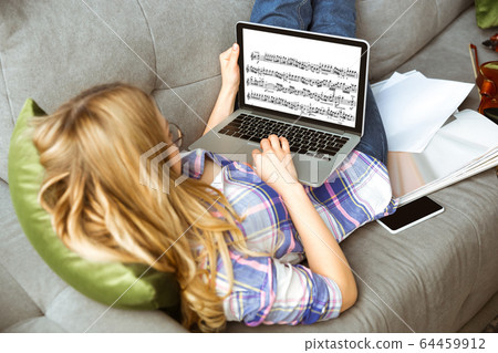 Young woman studying at home during online courses or free information by herself Young woman studying at home during online courses or free information by herself 64459912