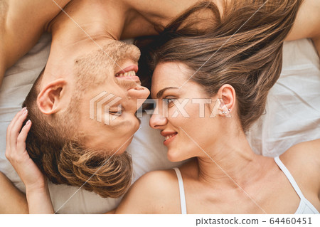 Positive delighted longhaired girl touching her man 64460451