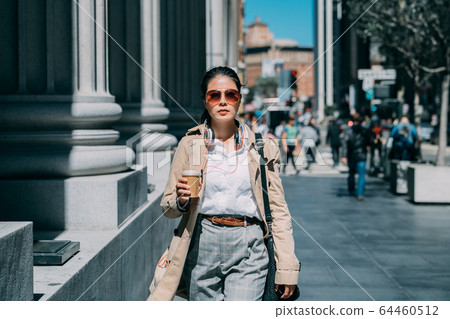 Woman outdoors listening to music with headphones 64460512