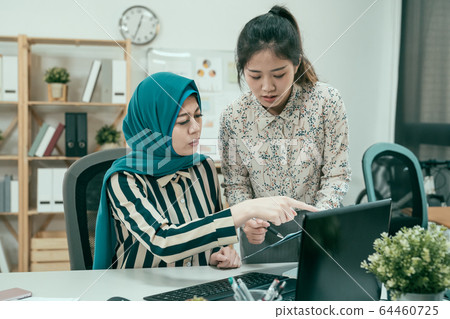 Arabic business woman wearing hijab and working 64460725
