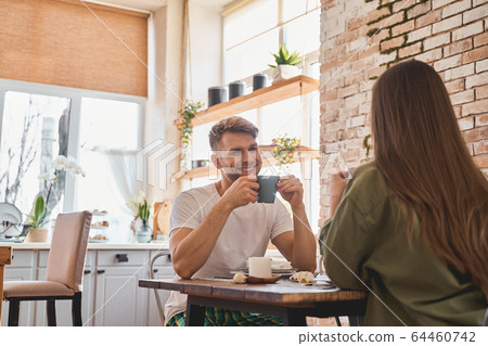 Positive delighted male person being in all ears Positive delighted male person being in all ears 64460742