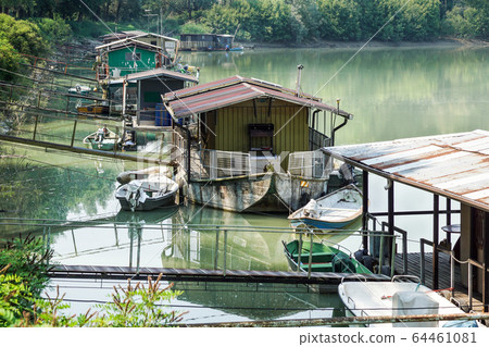 houseboat parked by the river near the swamp 64461081