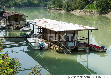 houseboat parked by the river near the swamp 64461082