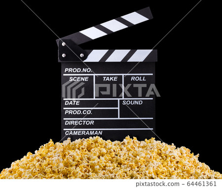 Flying popcorn and film clapper board isolated on black background 64461361